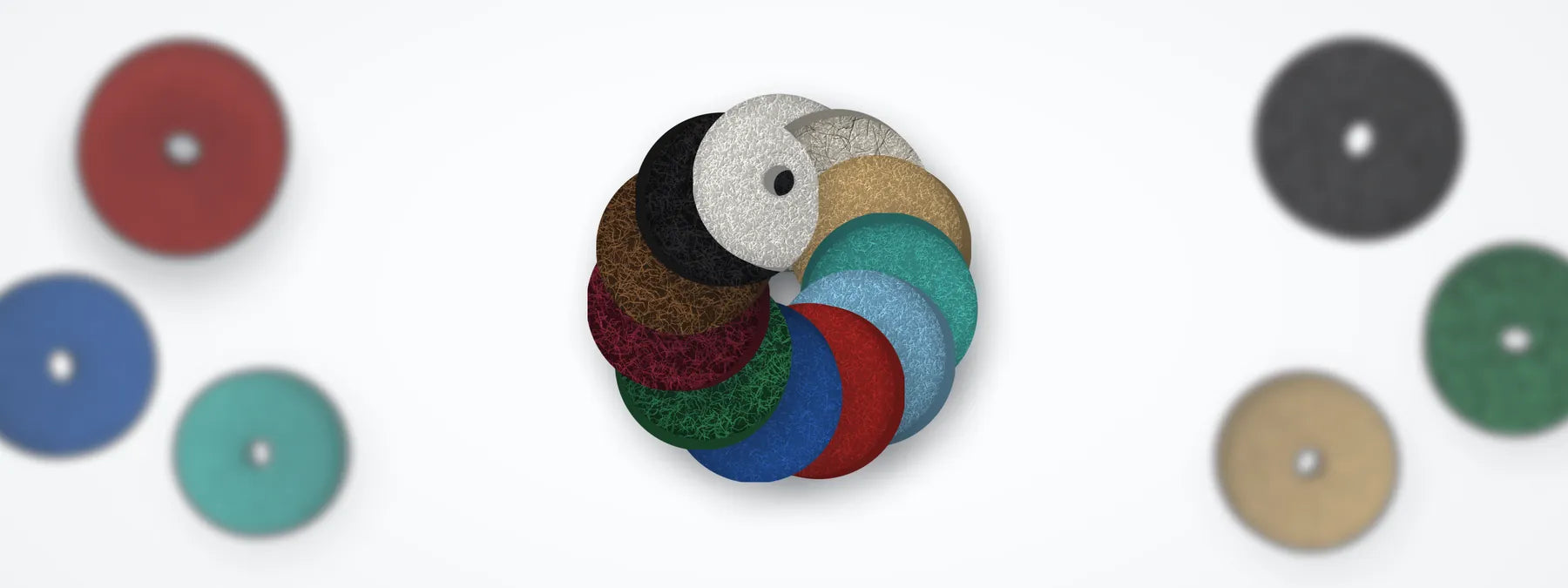 Floor pads in white, natural blend, tan, aqua, sky blue, red, blue, green, maroon, brown and black, fanned in a ring