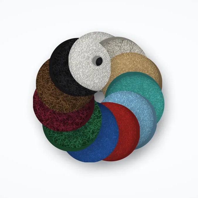 Floor pads in white, natural blend, tan, aqua, sky blue, red, blue, green, maroon, brown and black, fanned in a ring