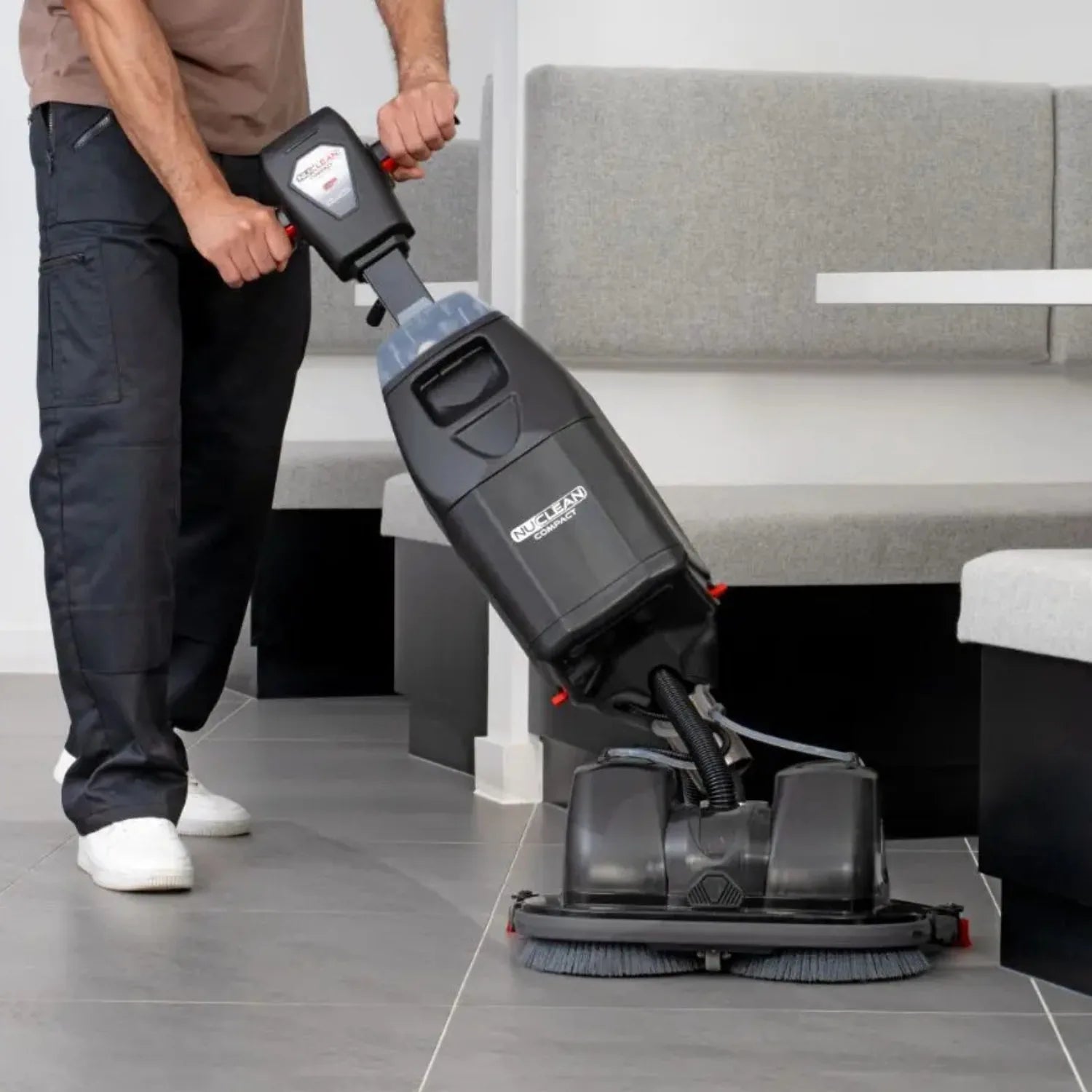 NaceCare 440NX Ultra-Compact Scrubber Trolley in use cleaning restaurant tables doing a tight turn