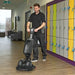 NaceCare 440NX Ultra-Compact Scrubber Trolley in use cleaning wooden floors in school corridor