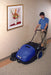 Clarke® BSW 28" Floor Sweeper - Front Left angle being used by operator near the walls.