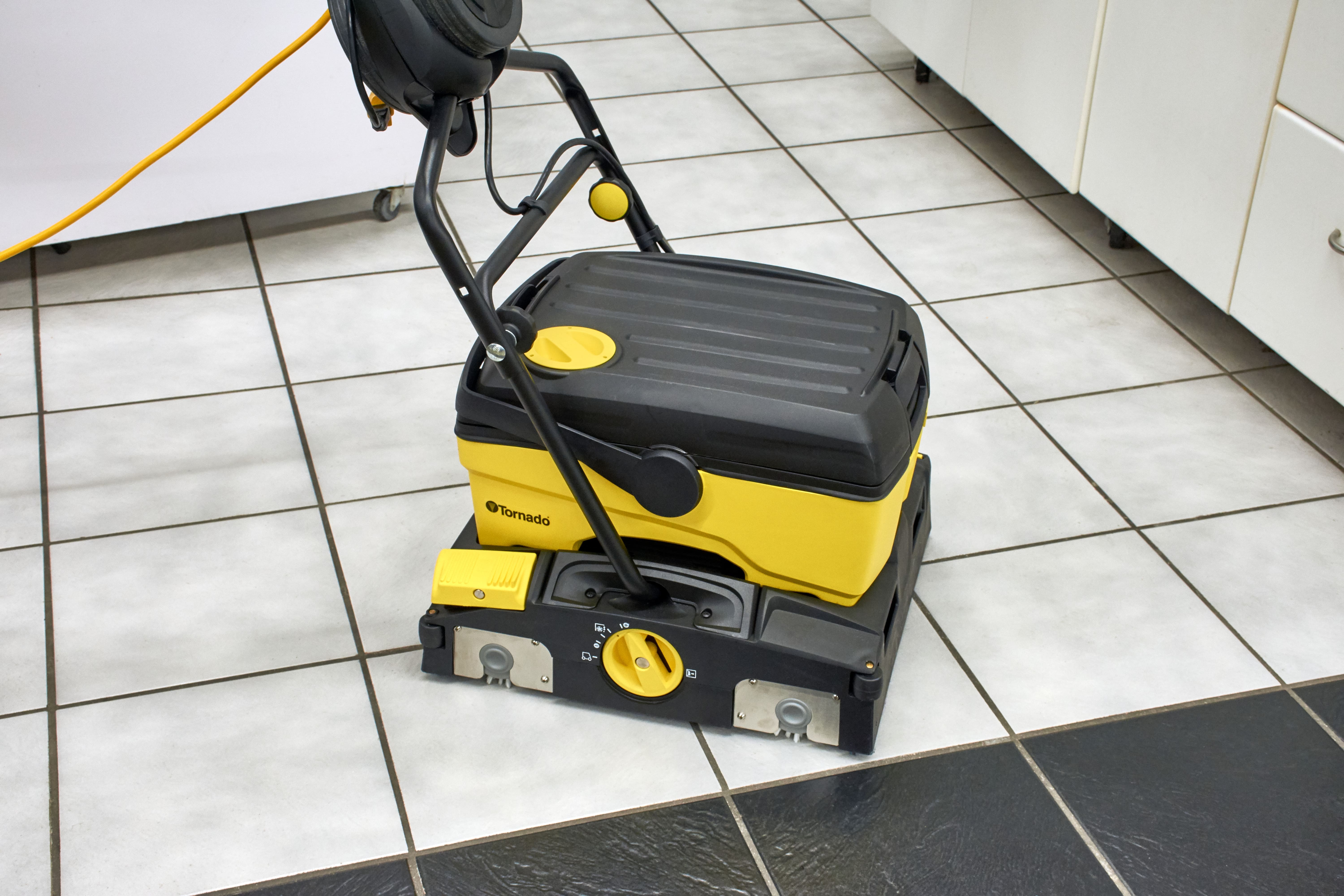 Tornado BR 16/3 Compact Automatic Scrubber Being Used On Kitchen Tile, Right Side Angle View