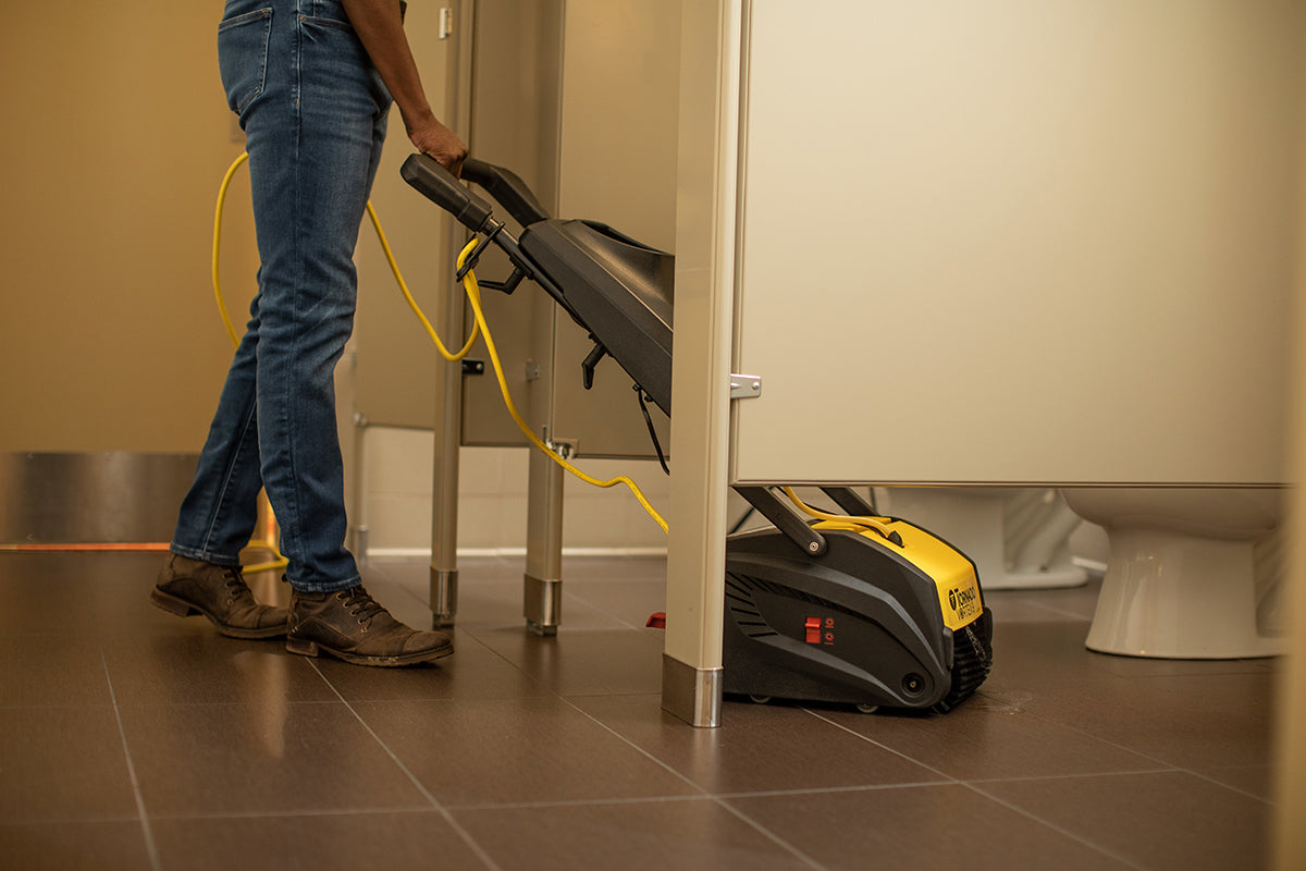 Tornado Vortex 9 Multi-Surface Scrubber In Use Cleaning a Public or Office Bathroom. It is compact enough to clean tight areas such as a toilet stall.