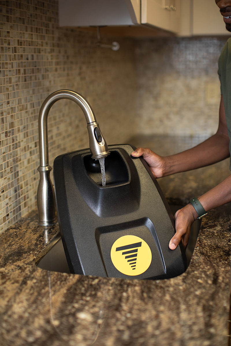 Tornado Vortex Multi-Surface Scrubber Tank being easily filled in the kitchen sink.