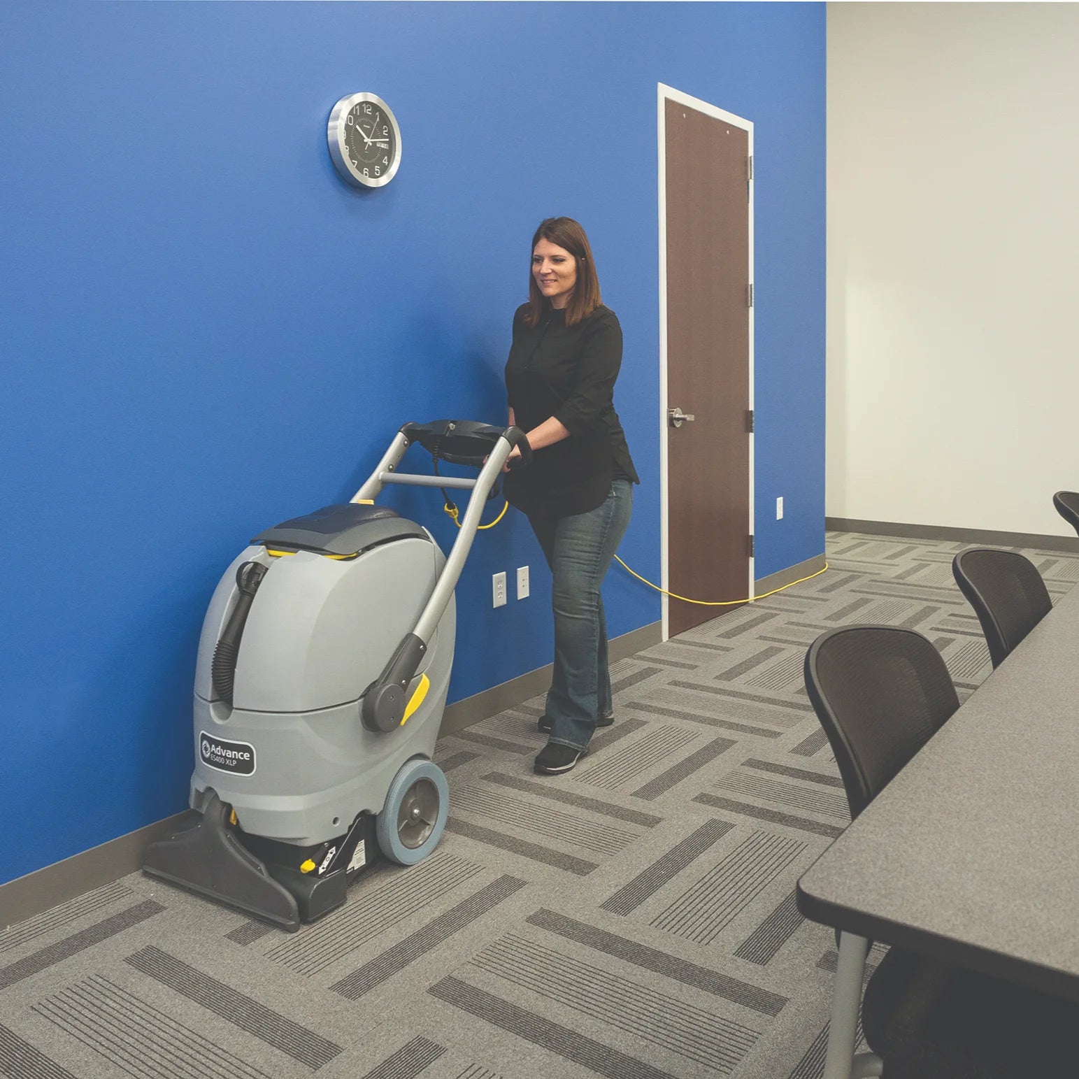 Operator cleaning conference room carpet with the ES400 XLP