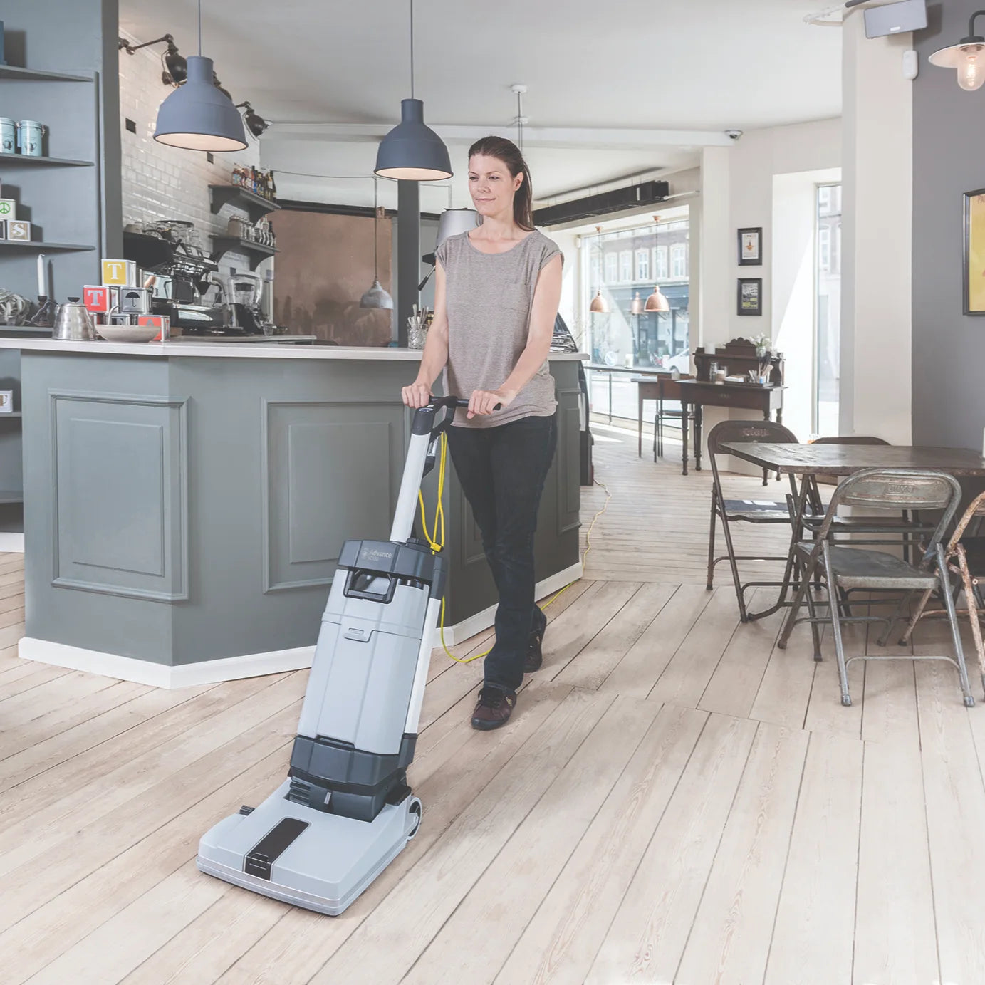 Scrubbing a cafe floor with the Advance SC100