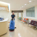 Custodian scrubbing a hard floor with the Clarke CA30 17E corded floor scrubber in a healthcare facility