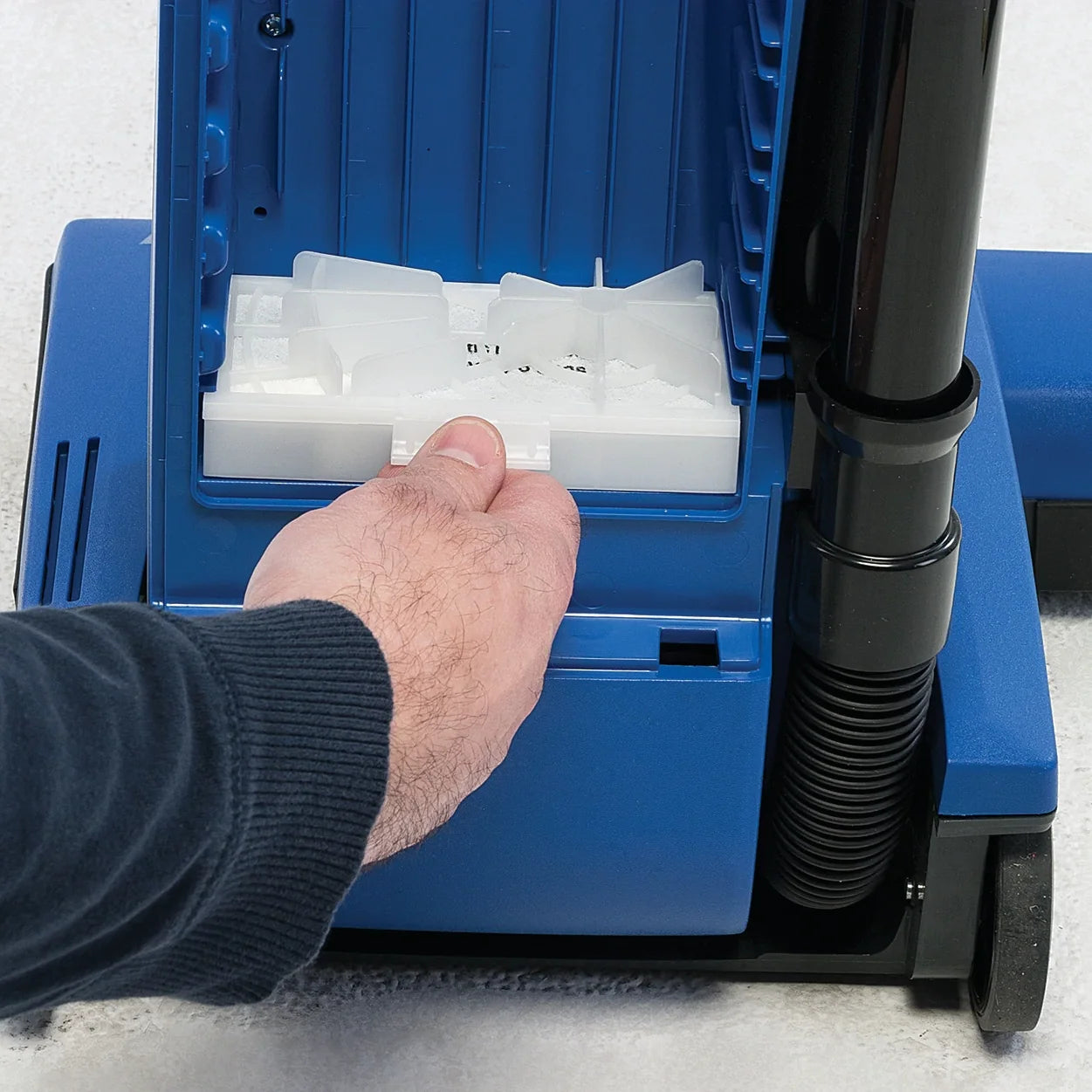 Filter being placed in the filter compartment of the Clarke CarpetMaster 115