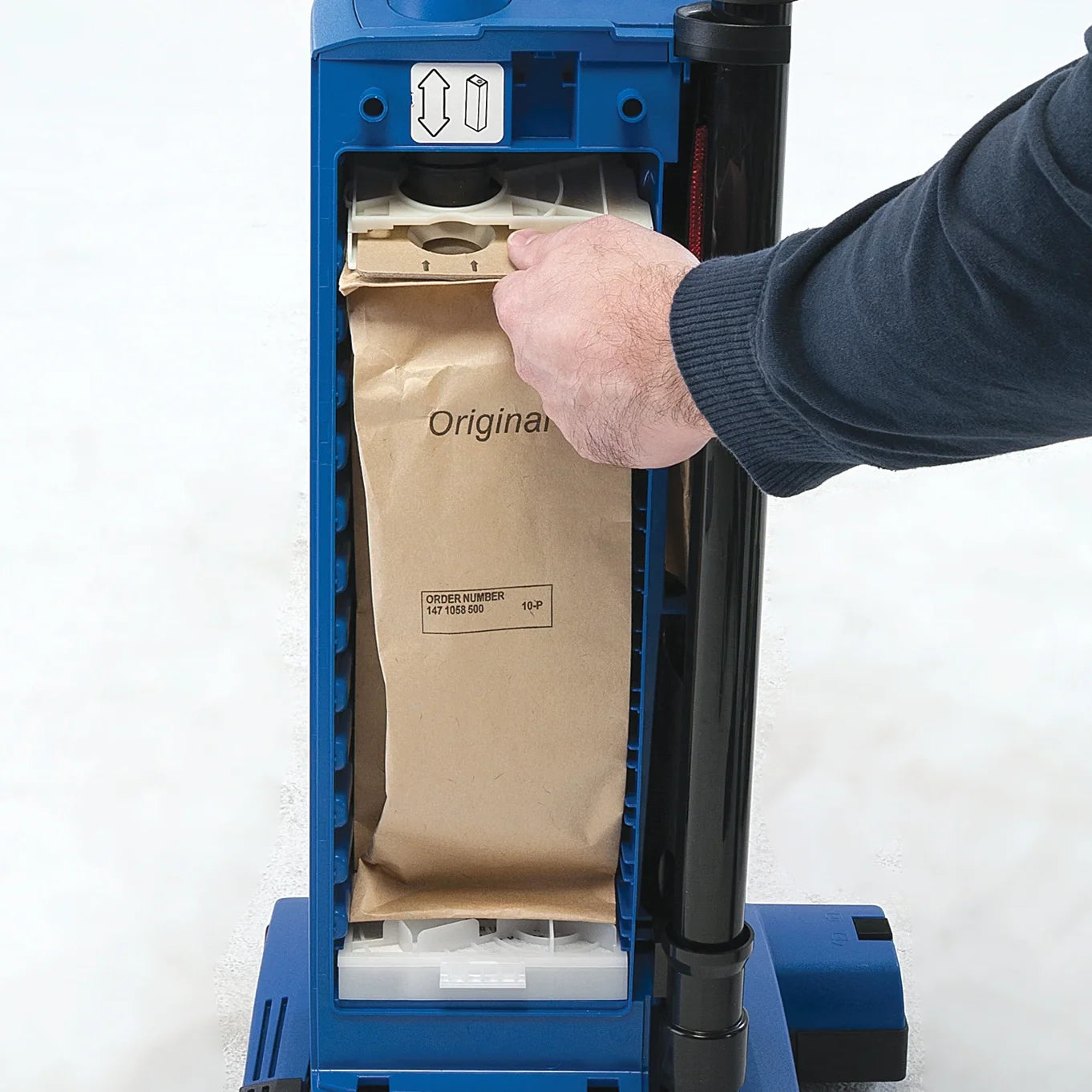 Paper dust bag being removed from the Clarke CarpetMaster 115