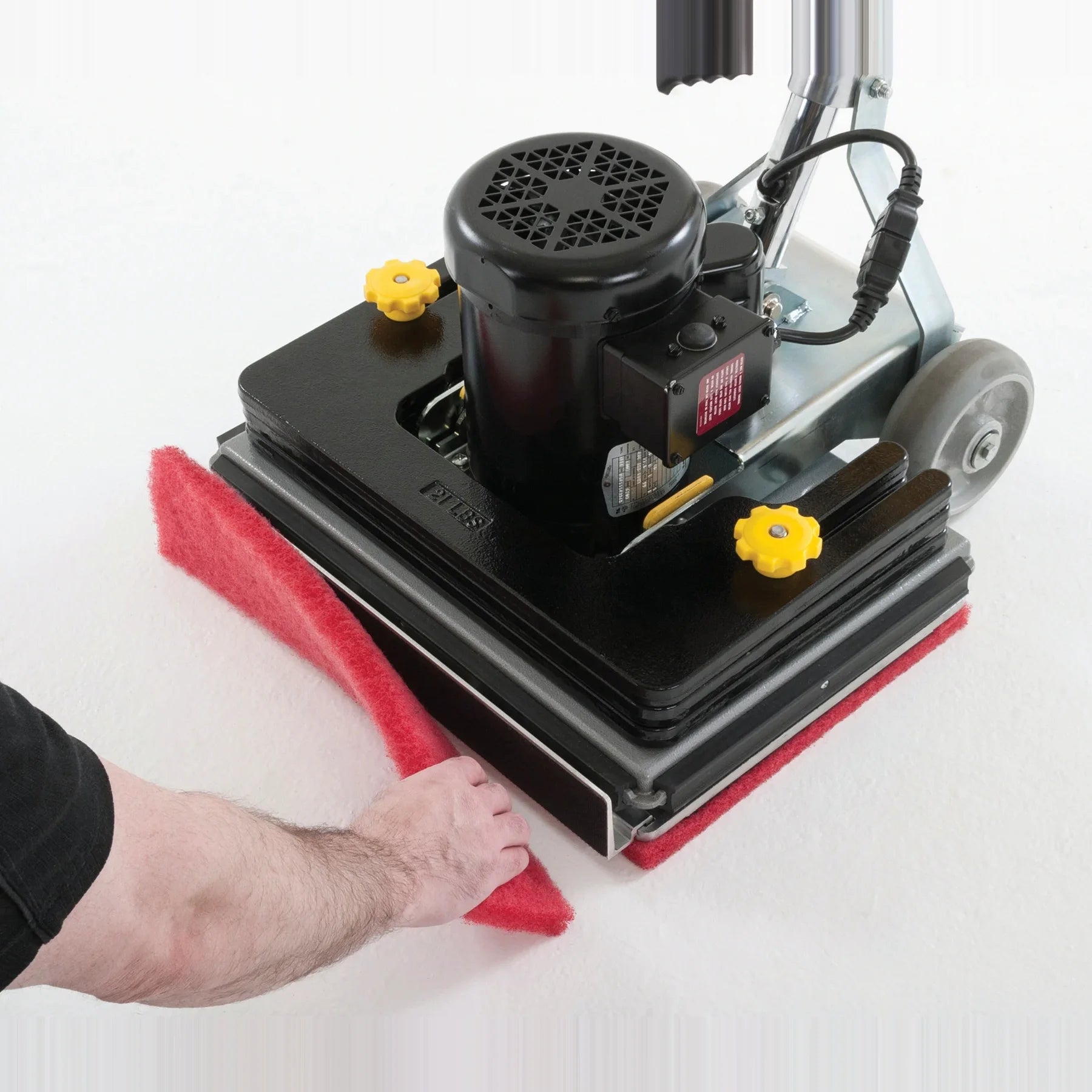 Changing the scrub pad on the baseboard cleaner attachment at the front of the Clarke FM40 LX