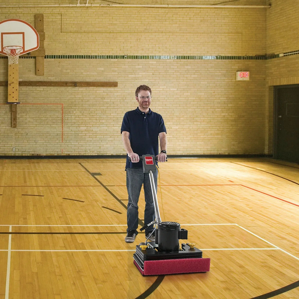 Clarke FM40 LX orbital floor machine in use on a gym floor