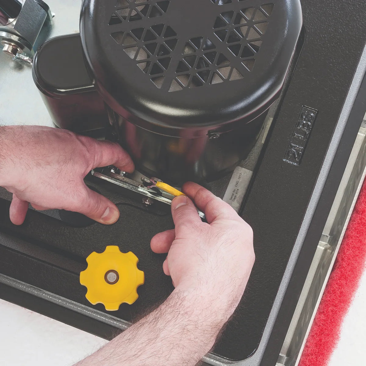 Releasing the handle from the base of the Clarke FM40 LX by hand, no tools needed