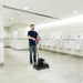 Clarke FM40 ST orbital floor machine scrubbing a restroom floor
