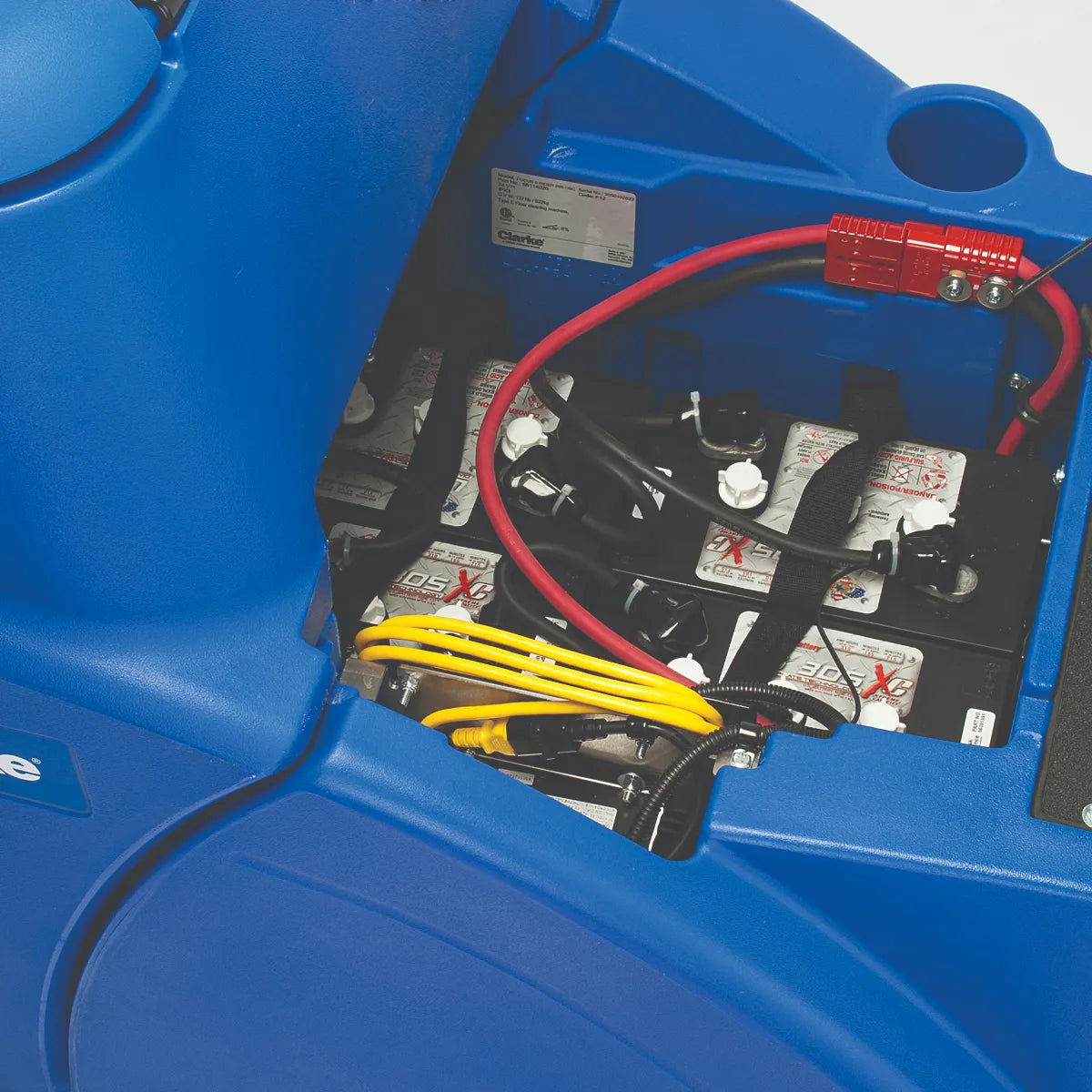 Battery compartment of the Clarke Focus II Rider under the raised seat, with the battery pack and cables