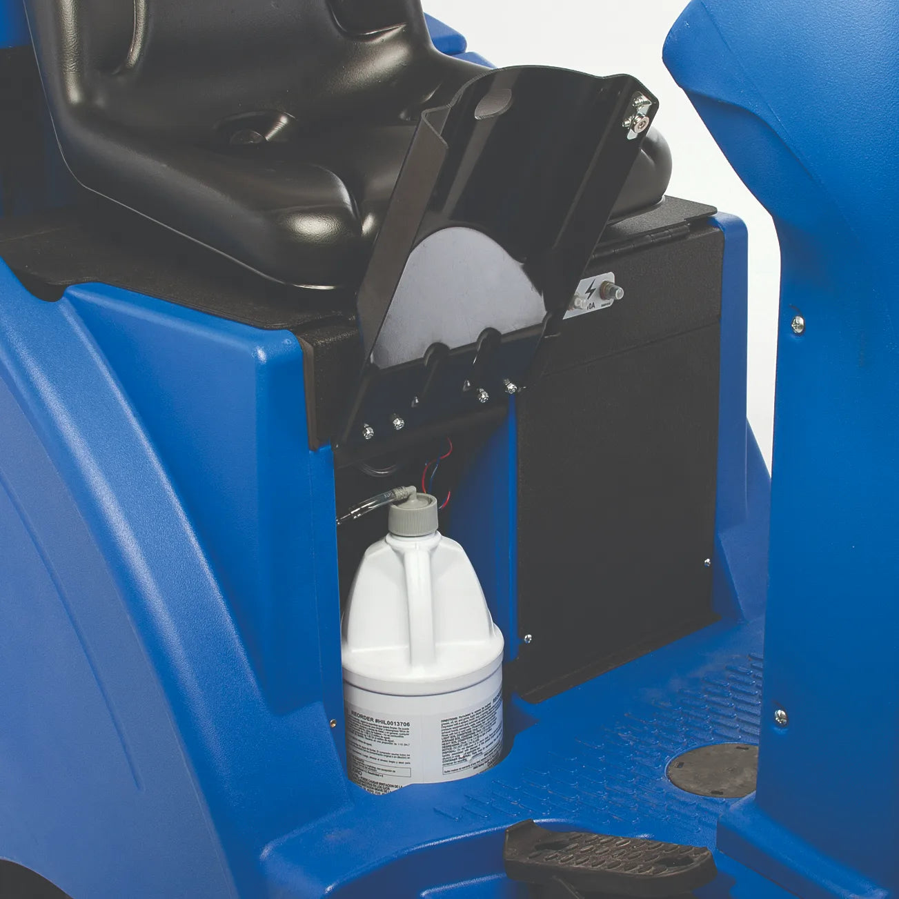 Chemical mixing system on the Clarke Focus II Rider, with the detergent container in its compartment beside the seat