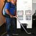 Operator wearing the EDIC Atlas backpack vacuum harness with the weight on the hips