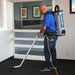 EDIC Atlas backpack vacuum worn by an operator vacuuming commercial carpet