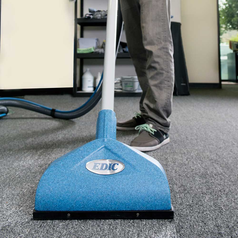 EDIC Triton lightweight aluminum dual jet carpet wand in use on commercial carpet