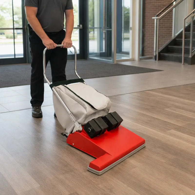 Operator vacuuming a wood floor with the Fas-Trak Fas-Vac cordless wide area vacuum