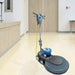ICE iB1500 floor burnisher standing on a glossy light floor in a lecture hall, beside a wood reception counter