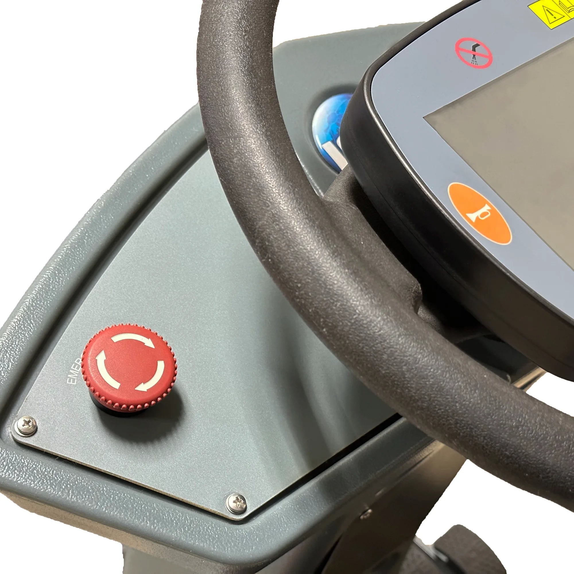 Close-up of the red emergency stop button on the dash of an ICE rider scrubber, beside the steering wheel and touch panel