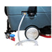 Clear fill hose plugged into the solution tank port on the side of an ICE rider scrubber, above the rear wheel
