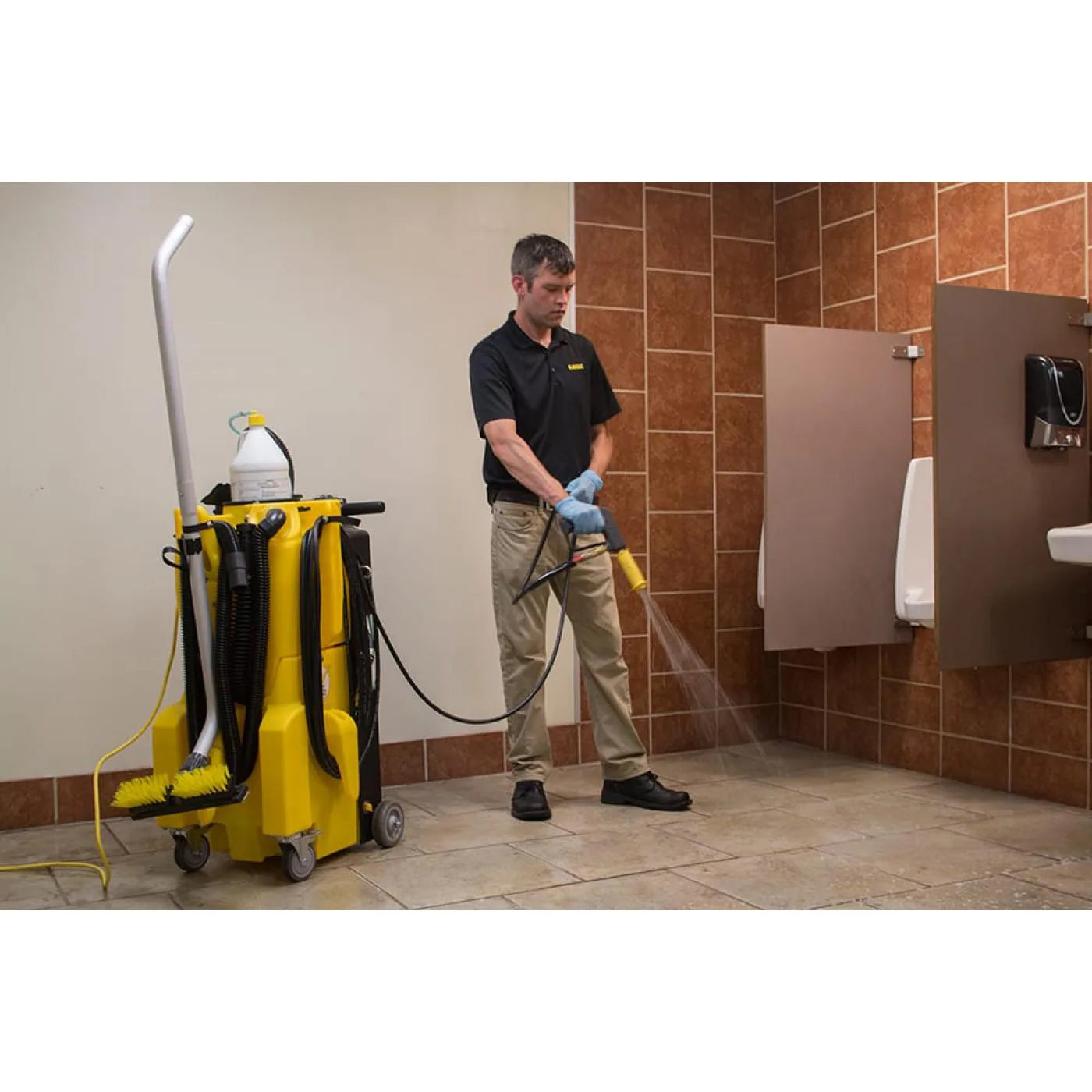 Yellow KaiVac 1250 machine on a tiled restroom floor during a cleaning job