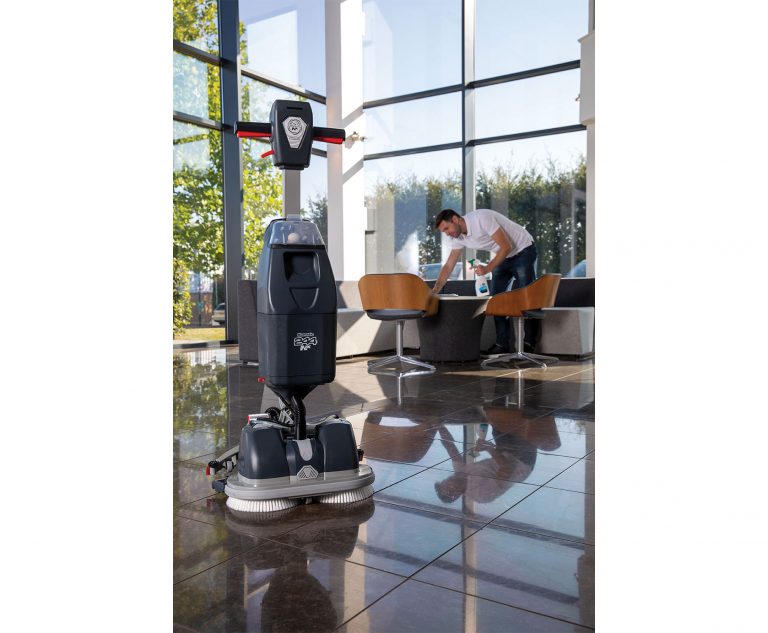 NaceCare 244NX Ultra-Compact Scrubber lifestyle image showing the machine in a lobby and shiny floors