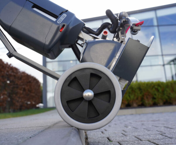 NaceCare 440NX Ultra-Compact Scrubber Trolley in use moving the machine moving over a curb