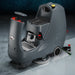 NaceCare CRL 2128 compact ride-on floor scrubber in a commercial building