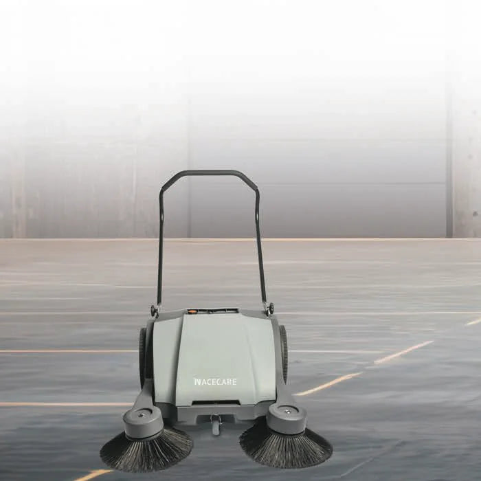 NaceCare NC 4 manual push sweeper on a concrete warehouse floor