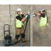 Workers drilling a wall with the TEL 390 HEPA vacuum ready to collect the dust