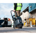 Worker pulling the TEL 390 by its trolley handle across a jobsite