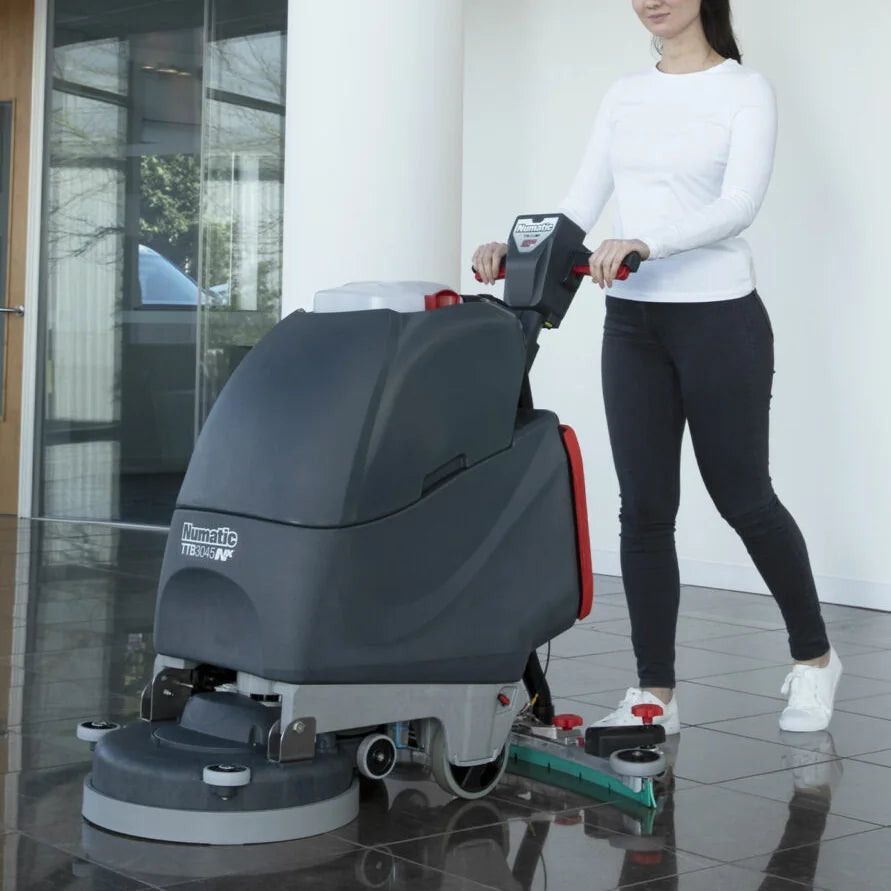 NaceCare TGB 817NX scrubber working in a lobby next to a glass wall