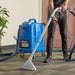 Operator extracting office carpet with the TP 8X wand while the box extractor stays parked behind
