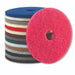 Stack of Nilfisk ECO round floor pads in several colors