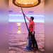 Cleaner dusting a ceiling light with the Borelli Dual Pro hose and metal wand
