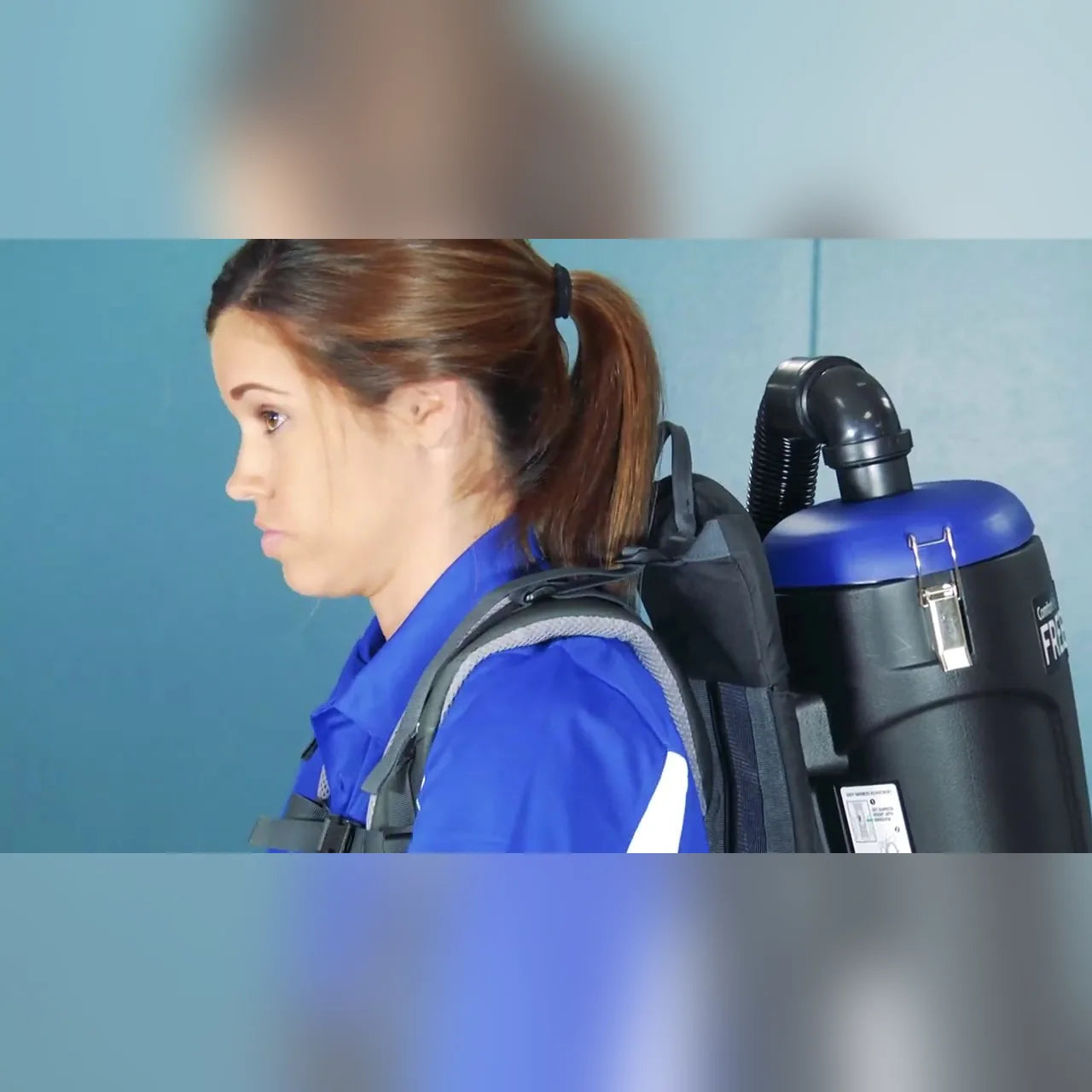 Operator wearing the Comfort Pro Freedom cordless backpack vacuum, side view
