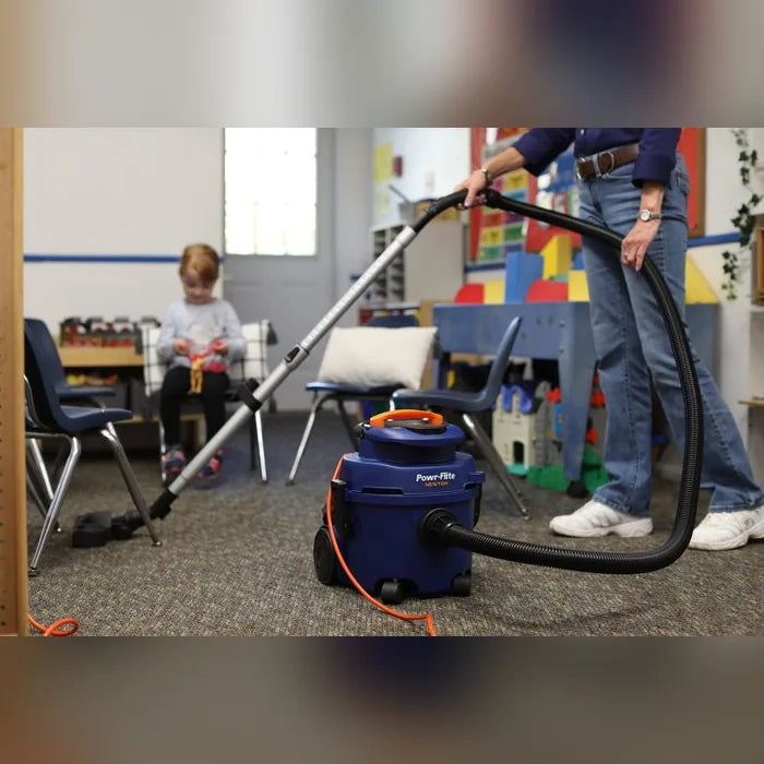 Vacuuming a classroom floor with the Powr-Flite Newton canister vacuum