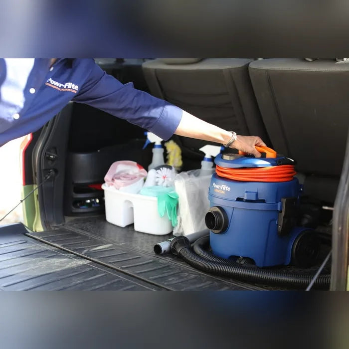 Lifting the Newton canister vacuum into a vehicle by its carry handle