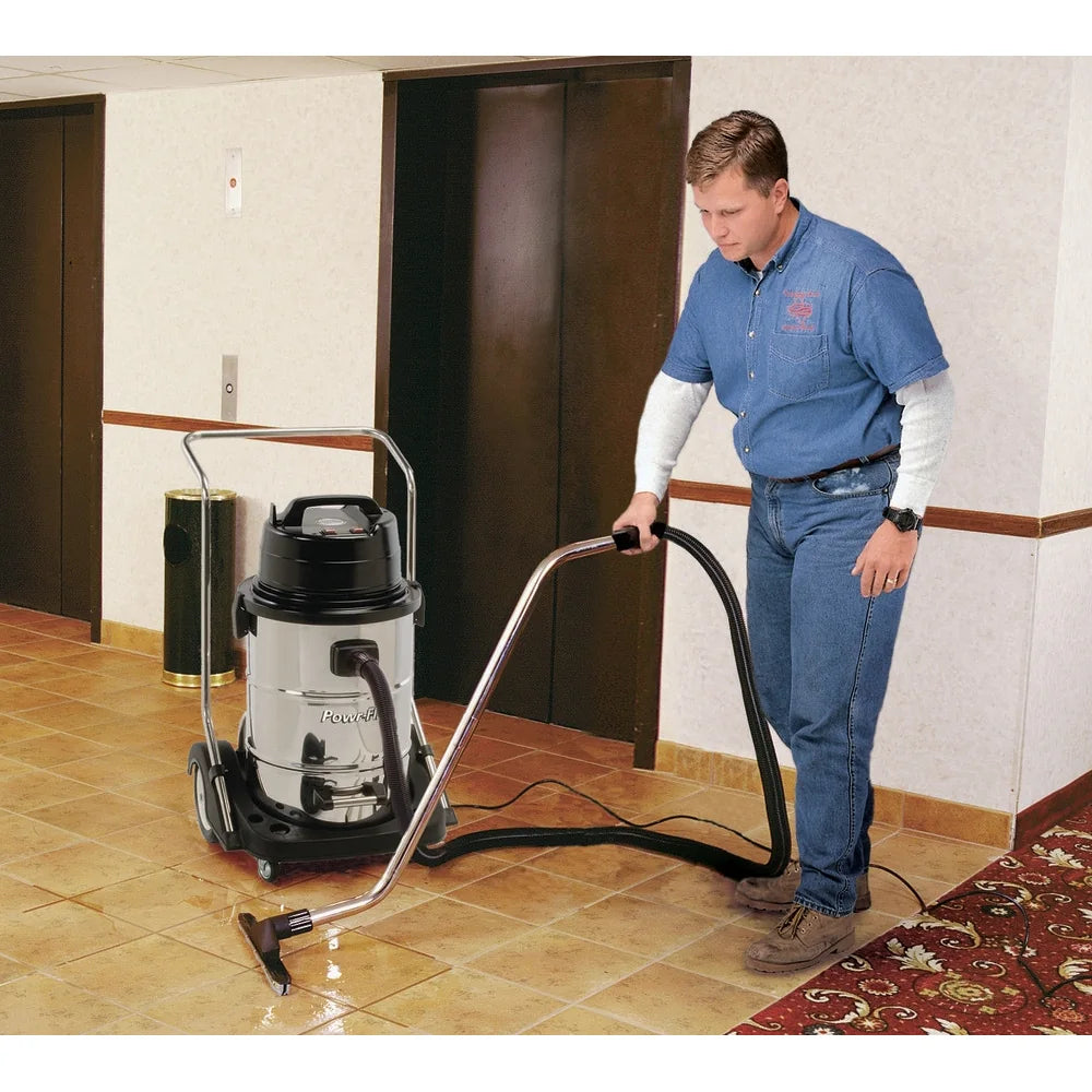Man using the Powr-Flite PF53 wet dry vacuum in a commercial hallway