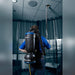 Operator reaching the ceiling of an office with the wand of a Comfort Pro backpack vacuum