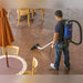Cleaner using the Pro-Lite BP4S floor tool on a stained concrete cafe floor