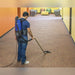 Cleaner vacuuming a carpeted hallway with the Pro-Lite BP4S backpack vacuum