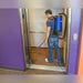 Cleaner vacuuming an elevator floor with the Pro-Lite BP4S backpack vacuum