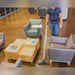 Cleaner vacuuming a lounge between sofas and a coffee table with the Pro-Lite BP4S
