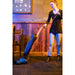 Woman vacuuming a carpeted room with the Powr-Flite Solar upright