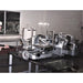 Operator steam cleaning commercial meat slicers in a food plant with a Therma-Steem industrial dry vapor steam cleaner