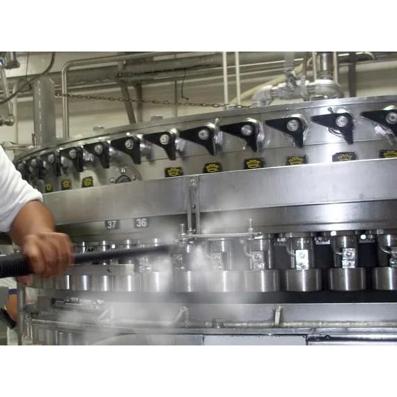 Operator steam cleaning a stainless food processing filler line with a Therma-Kleen high-pressure steam wand