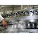 Operator steam cleaning a stainless food processing filler line with a Therma-Kleen high-pressure steam wand